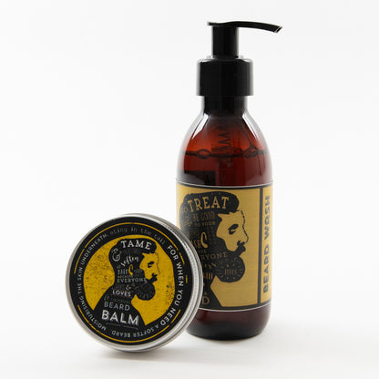 Beard balm tin and beard wash bottle pictured on a white background. Both items have yellow and black labelling featuring an illustration of a man's face in profile with a thick beard.