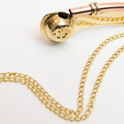 A close-up of a replica bosun's call comes with a matching 50-inch neck chain and swivel snap-hook. Pictured on a white background.