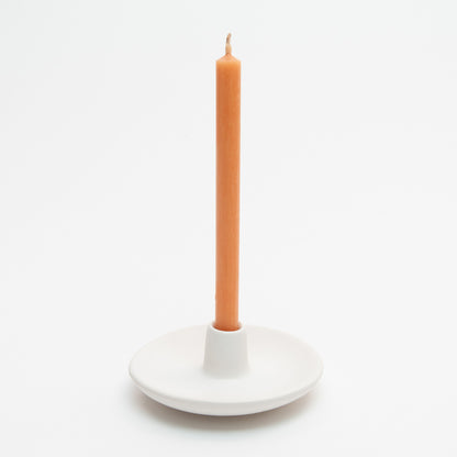 St Eval Mini Candle Holder. Small ceramic white dish with holder protruding up from centre, containing a St Eval Orange and Cinnamon Candle.