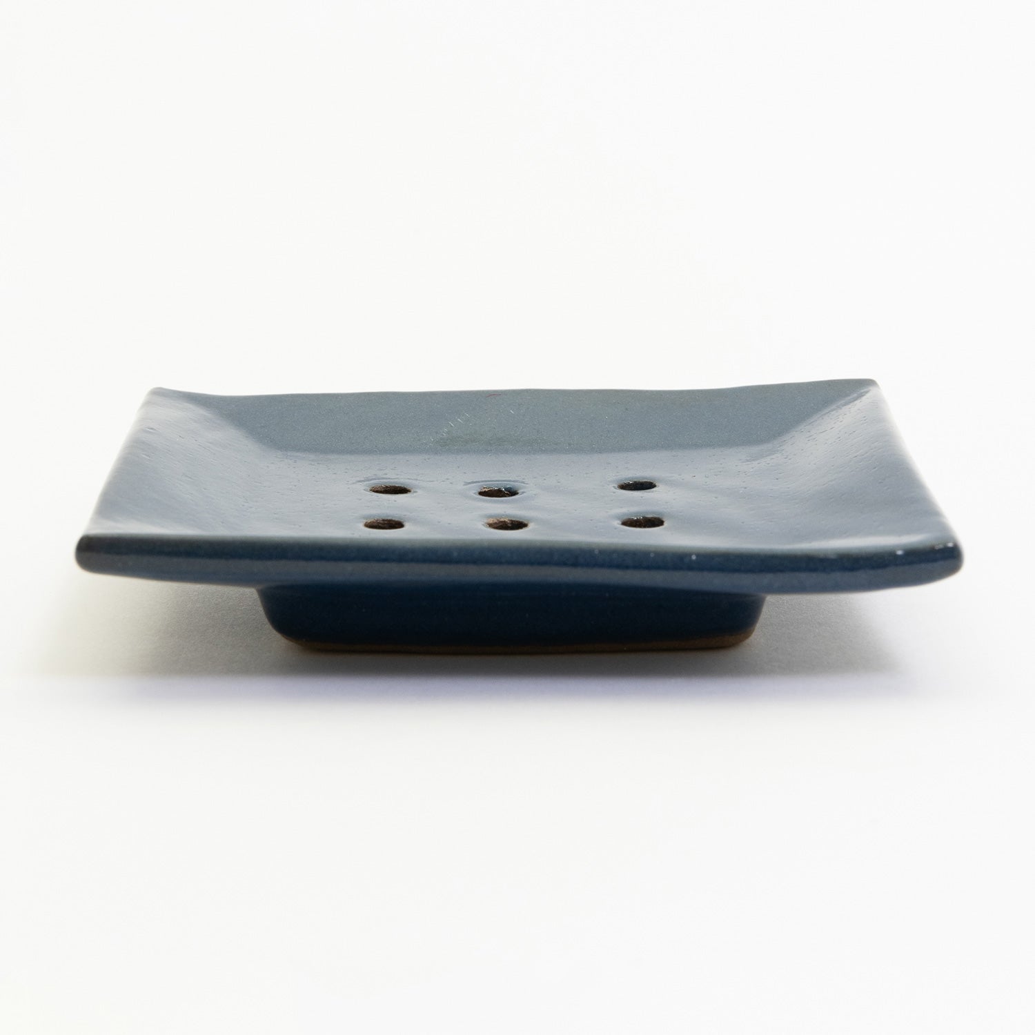 A cobalt blue stoneware soap dish pictured on a white background.