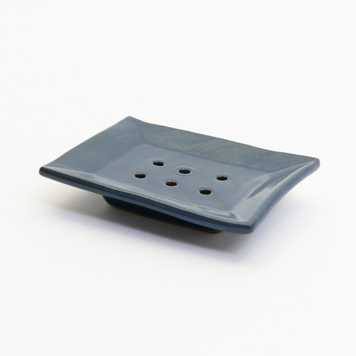 A cobalt blue stoneware soap dish pictured on a white background.