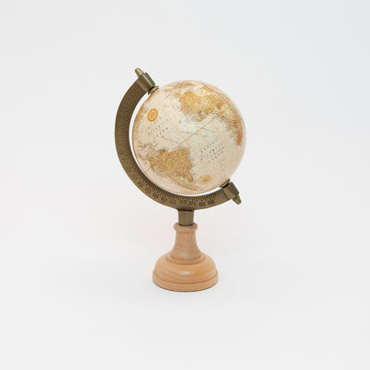A globe with political-style mapping with a sepia-toned antique effect, mounted onto a steamed beech pedestal. Photographed on a white background.