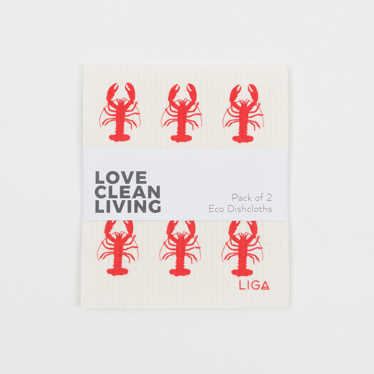 Dishcloth with a red lobster pattern on a light cream background in its packaging.