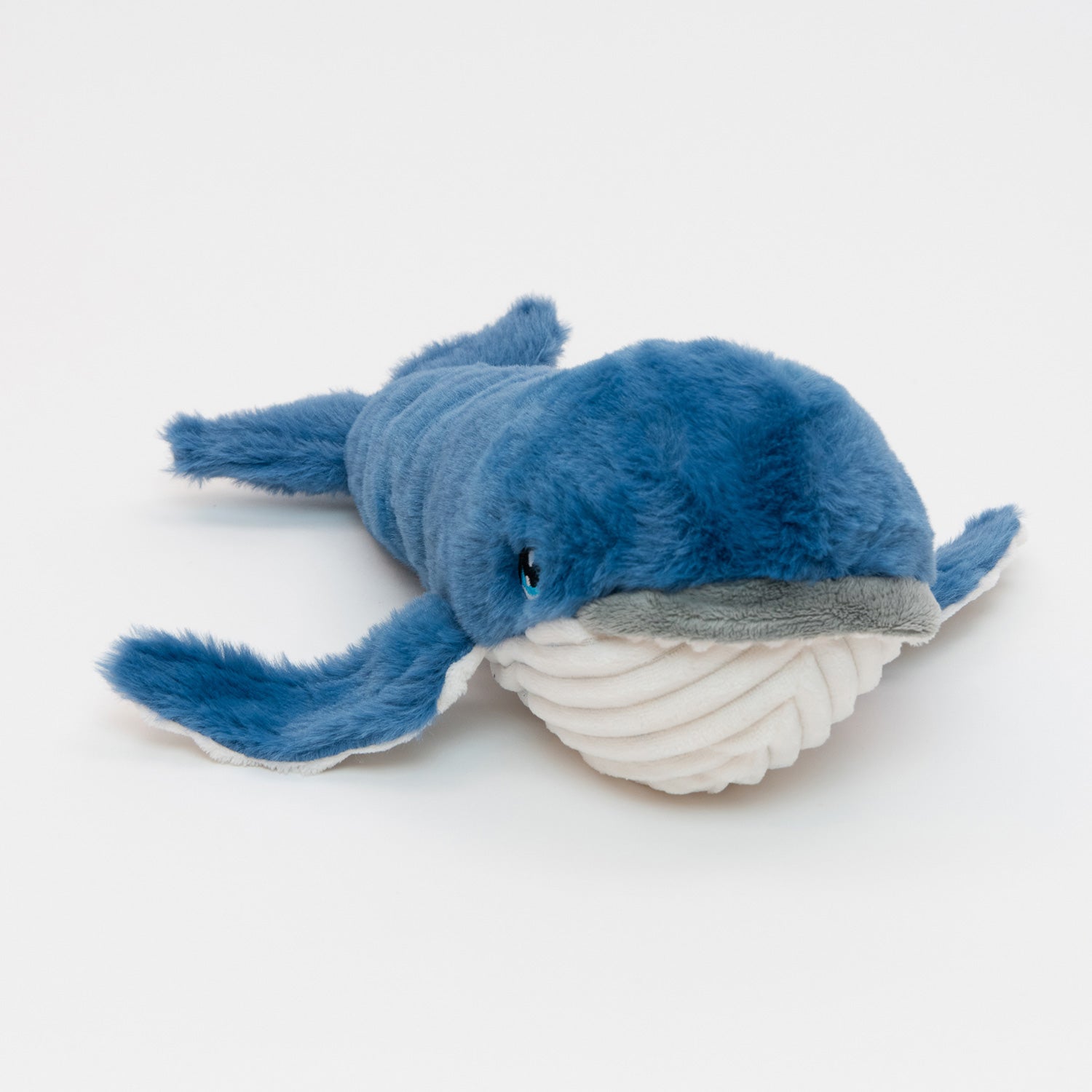 A blue and white plush whale soft toy, pictured on a white background.