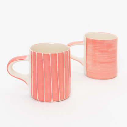 shot of 2 Espresso cups one with pink wash with thin white vertical stripes and the other in plain pink wash