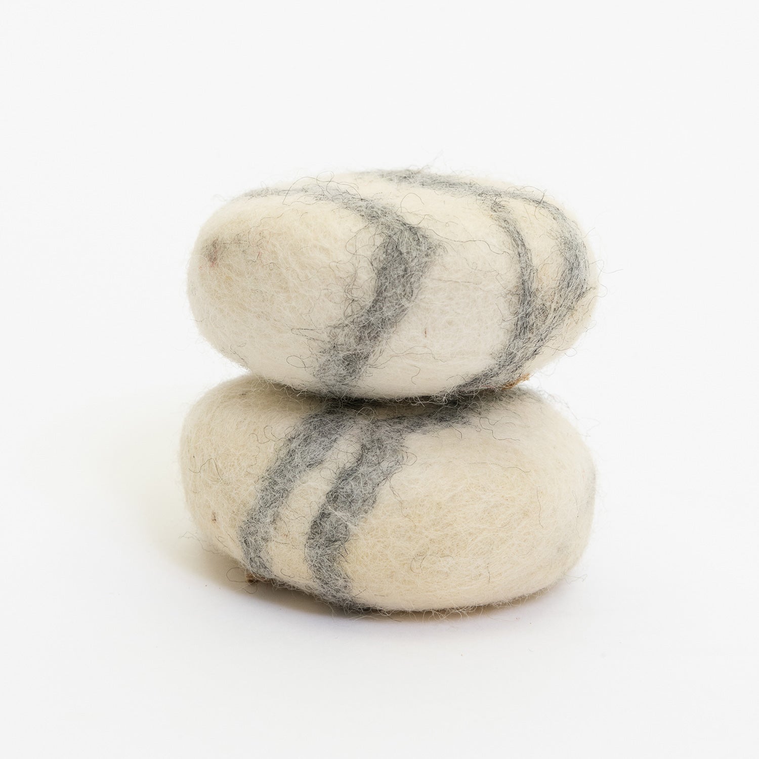 Two felt soap bars pictured on a white background. They are round and have a grey stripe marble style.
