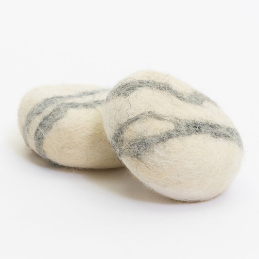 Two felt soap bars pictured on a white background. They are round and have a grey stripe marble style.
