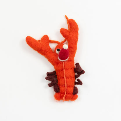 A Christmas lobster decoration on a white background. The decoration is an orange felt lobster wearing a red Christmas hat.