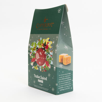 A pack of festive spiced fudge pictured on a white background. The pack is dark green with a red bauble illustration at the centre, surrounded by festive imagery.