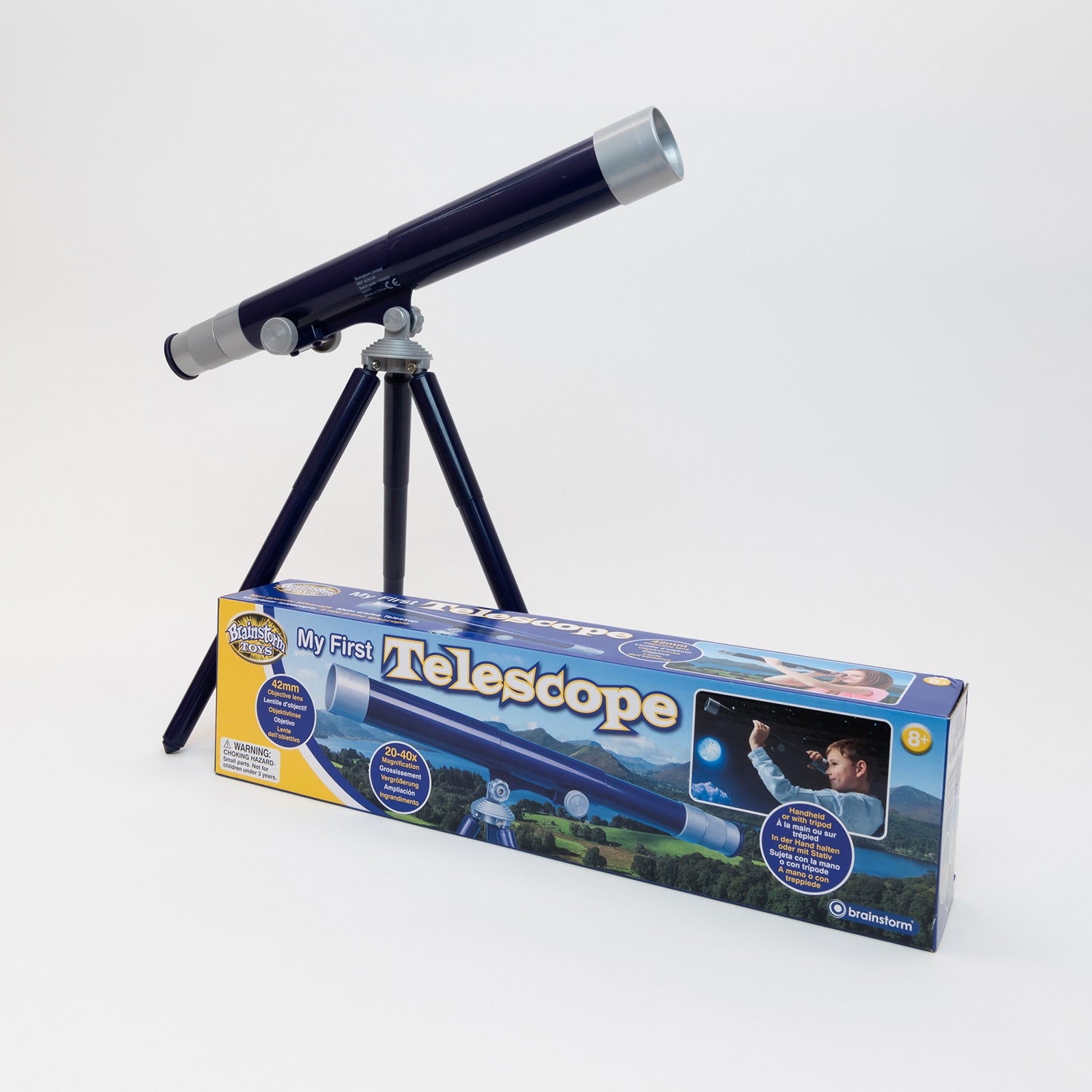 A blue telescope on a stand behind the My First Telescope box.
