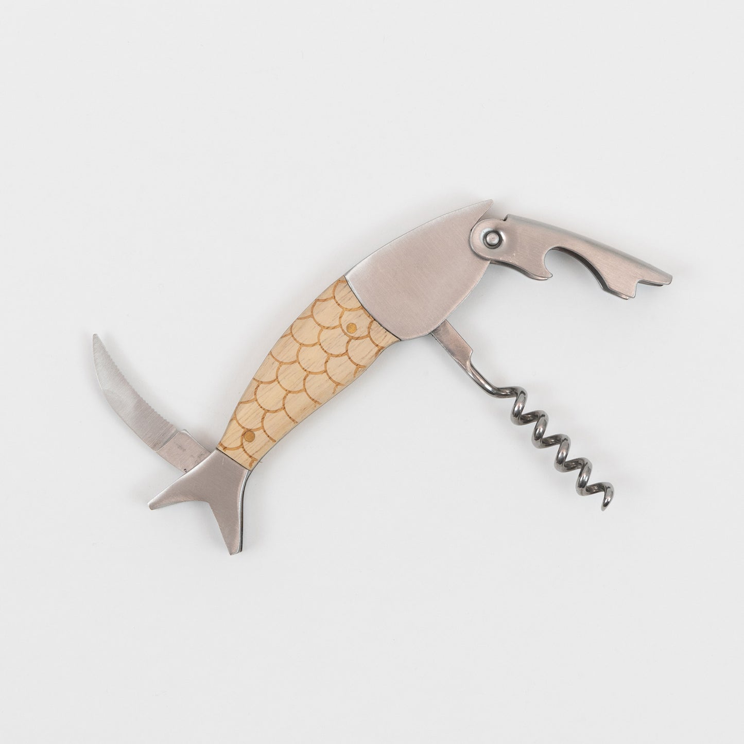 Top down view of the metal and wood fish bottle opener with the cork screw, bottle cap and pen knife on display.