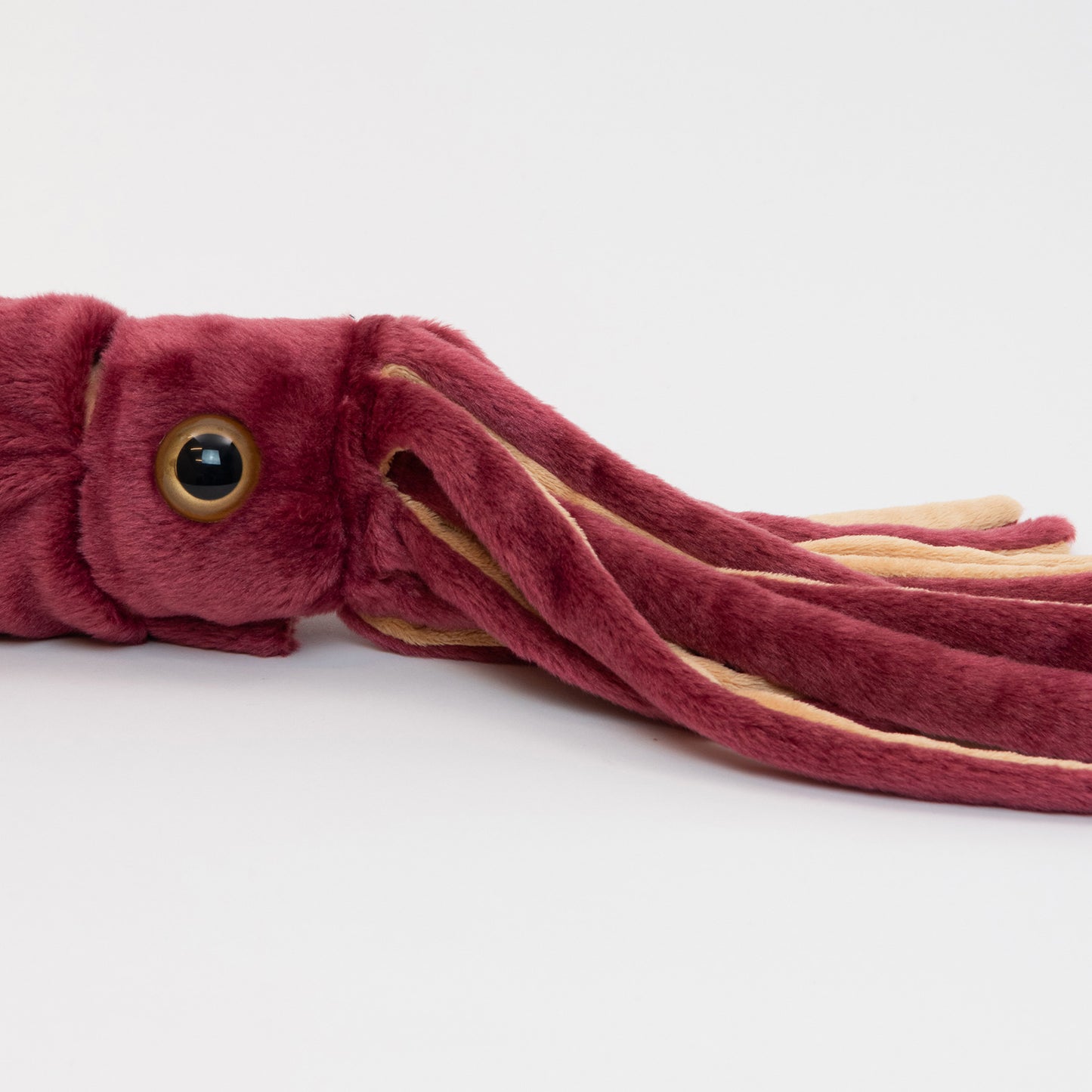 A red plush squid pictured on a white background.