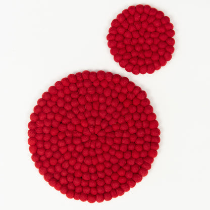 A red felt ball trivet and a red felt ball coaster pictured on a white background.
