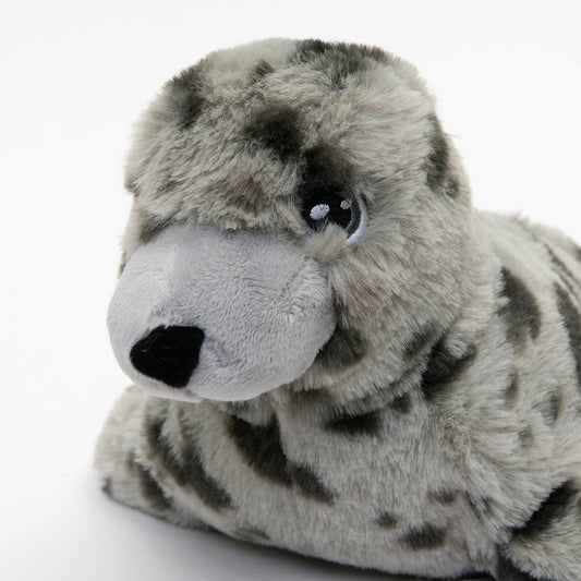 close up of eye and nose of light and dark grey spotted plush seal