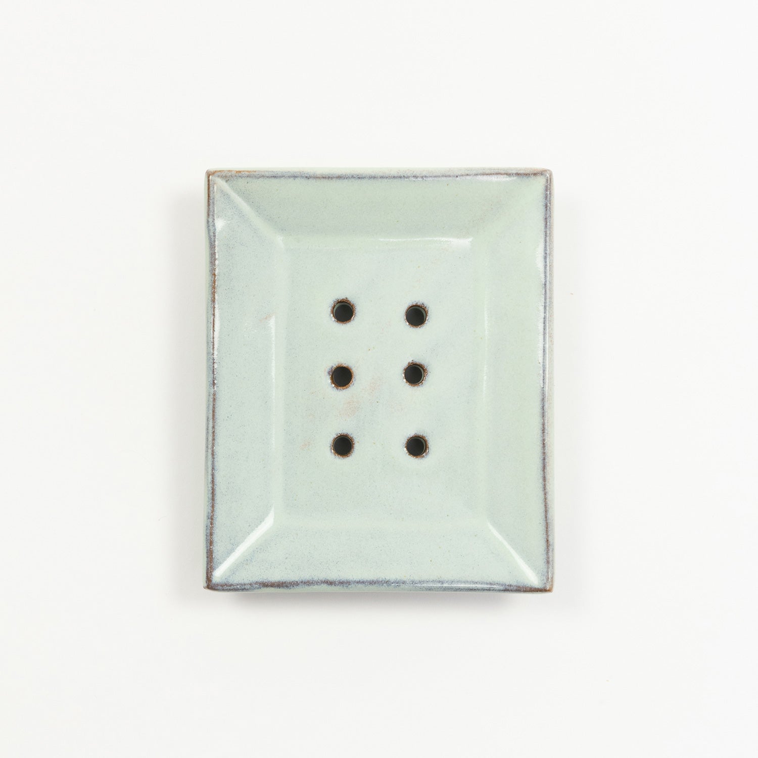 A stoneware soap dish in ice blue colour. Pictured on a white background.