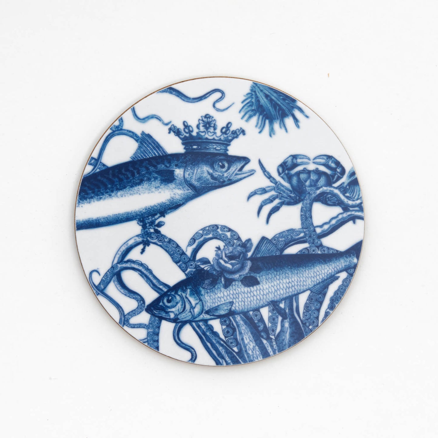 Blue and white image of fish wearing crown on a round coaster