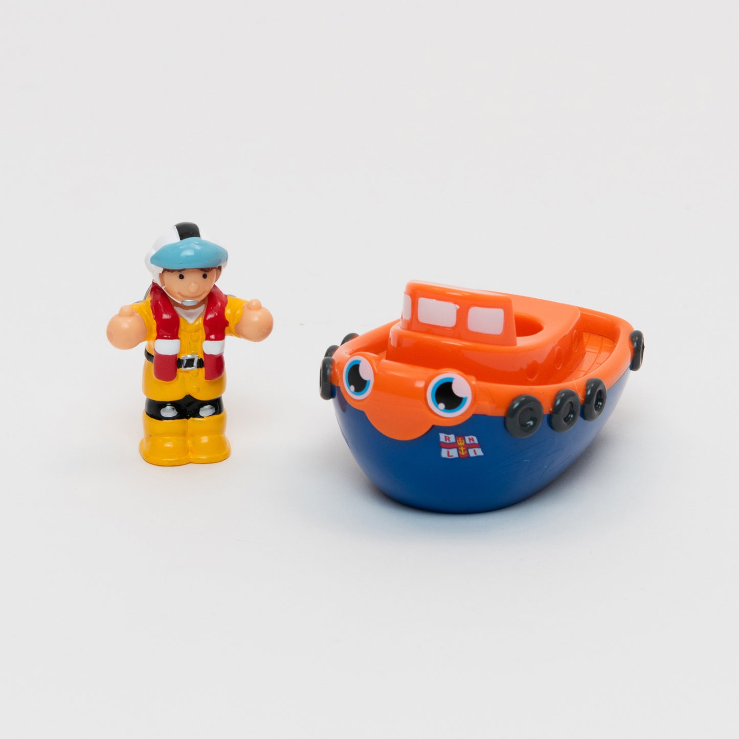RNLI Lifeboat Lily Bath Toy.  Orange and Blue cartoon lifeboat toy with detachable RNLI team member Lily in her yellow waterproofs and helmet.