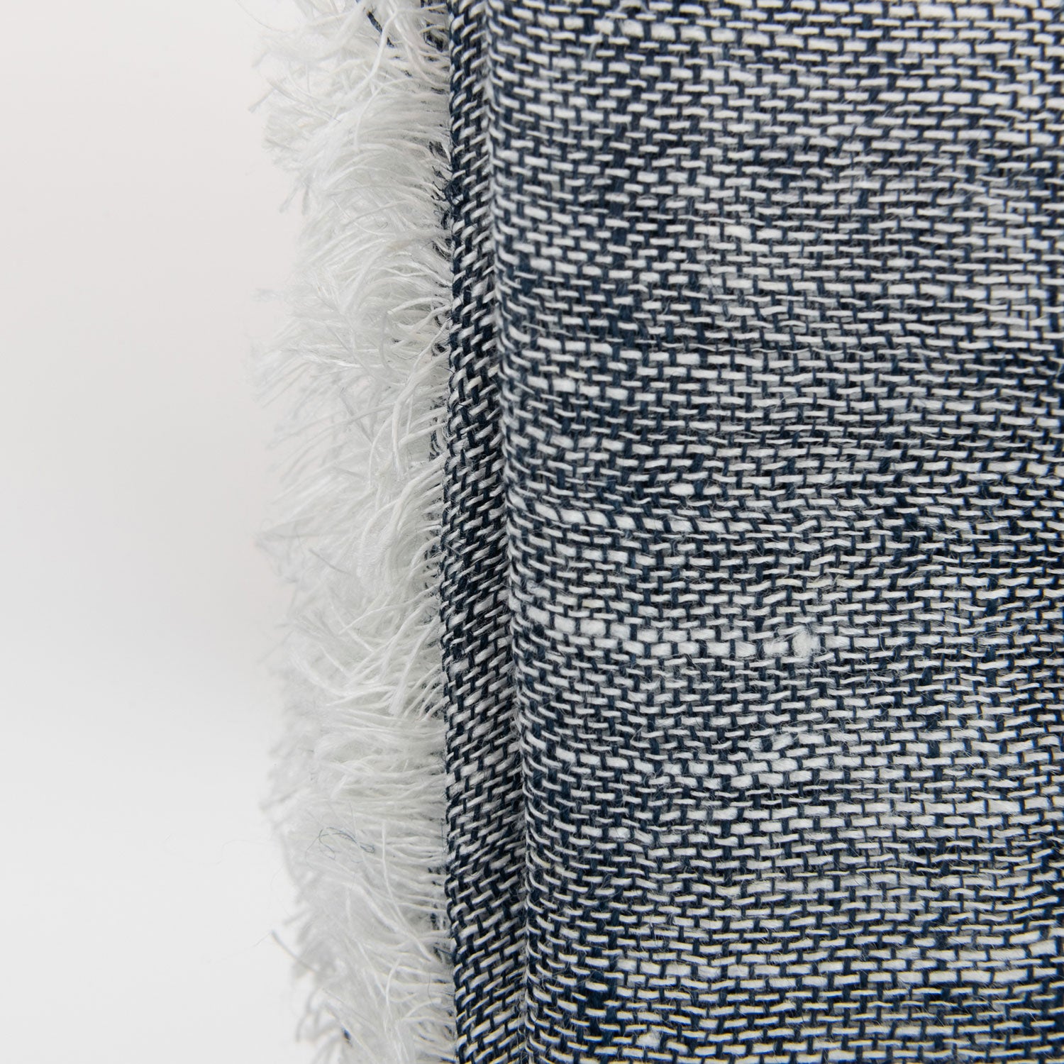 A close-up photo of the denim blue linen scarf on a white background.