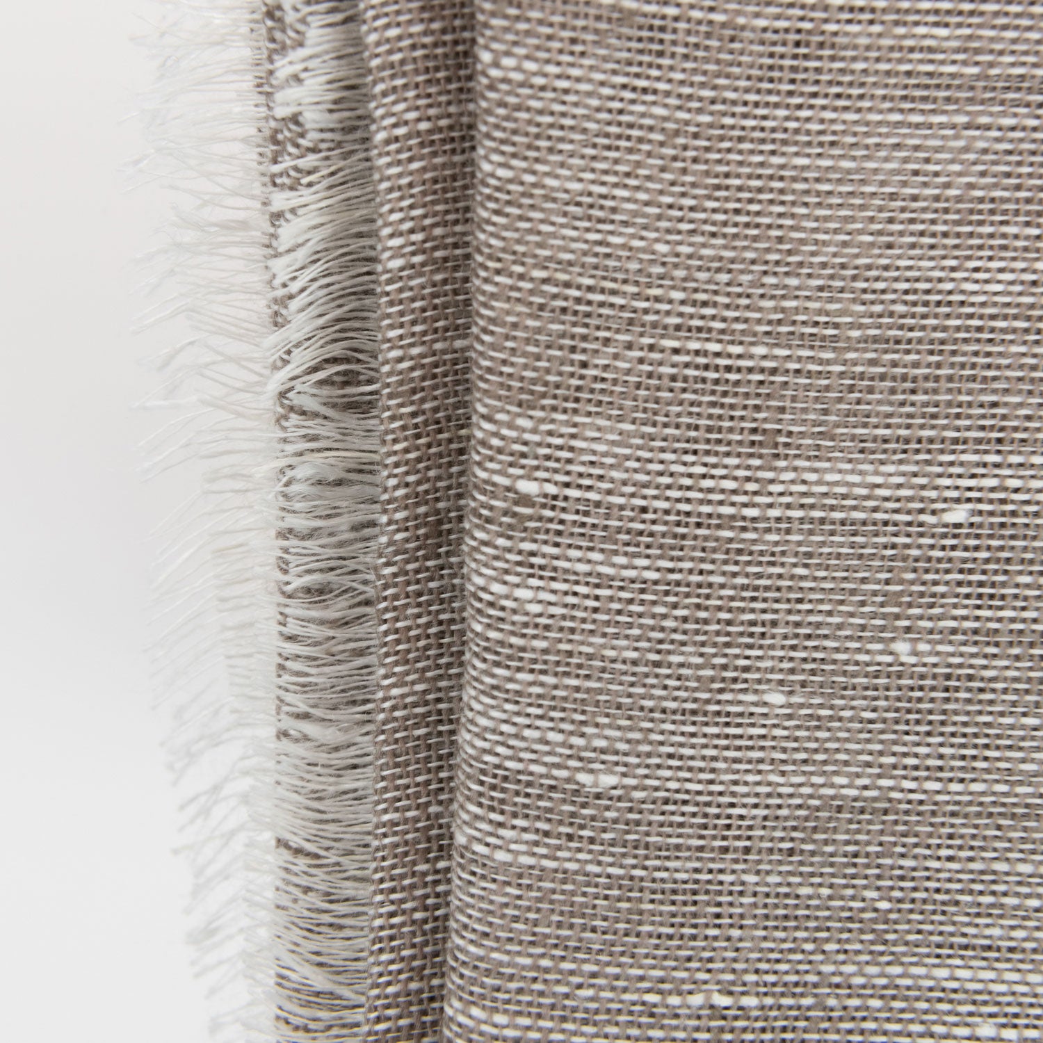 A close-up photo of the sand linen scarf on a white background.