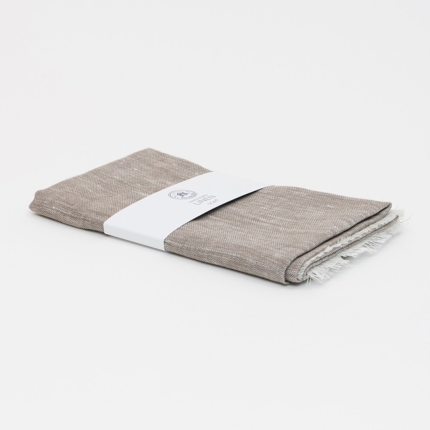 A photo of the sand linen scarf on a white background. 