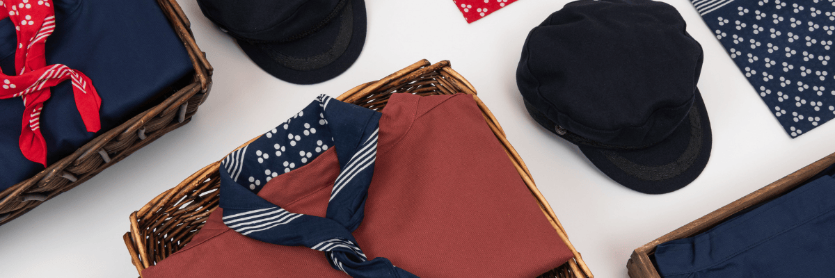 Collection of hats and scarves on a white surface