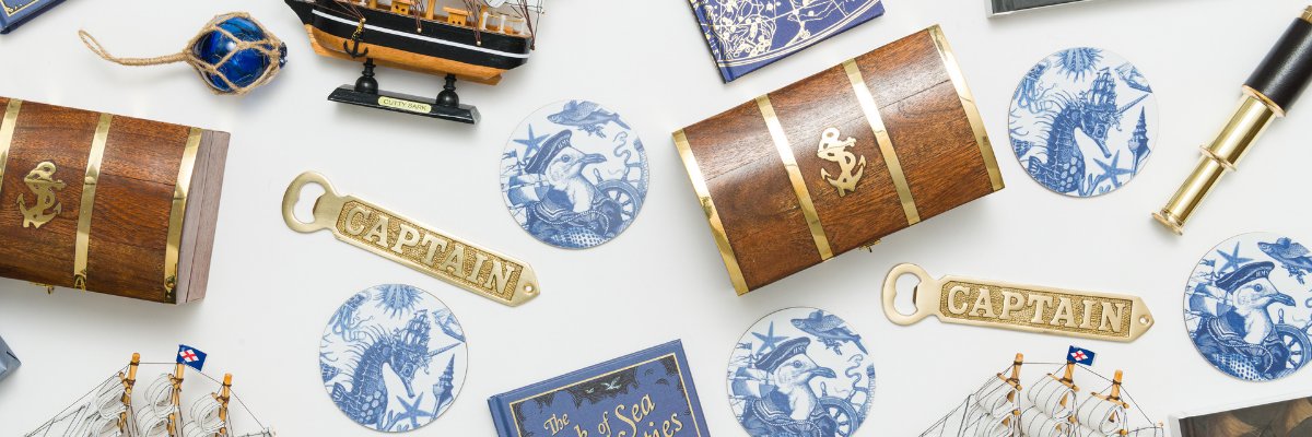 Collection of decorative items including wooden barrels, 'CAPTAIN' bottle opener, and ship models on a white background.