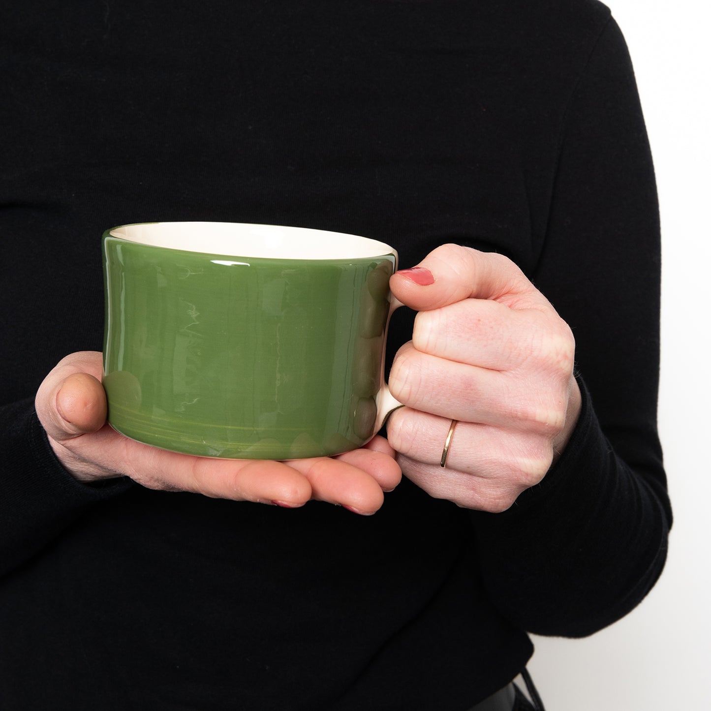 Shot of someone holding the mug to show size