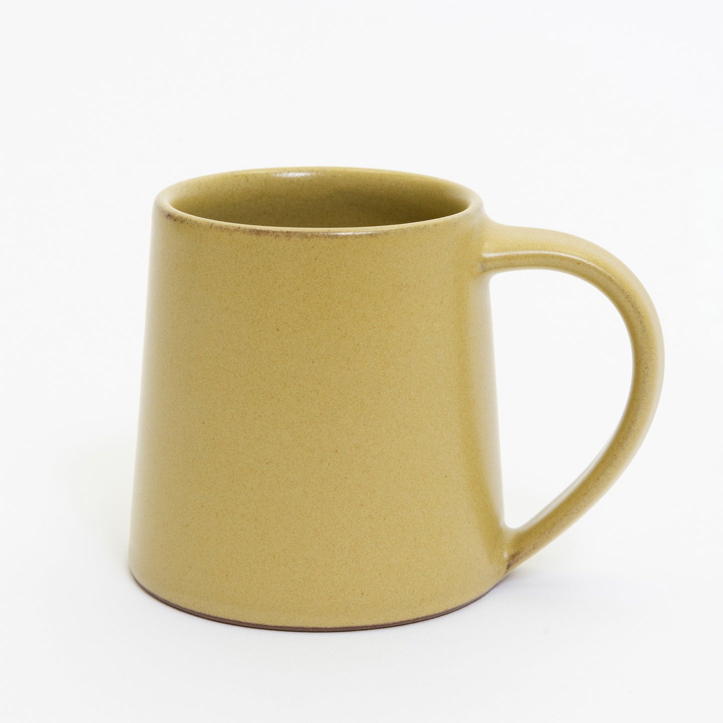 A mustard-yellow stoneware mug pictured on a white background.