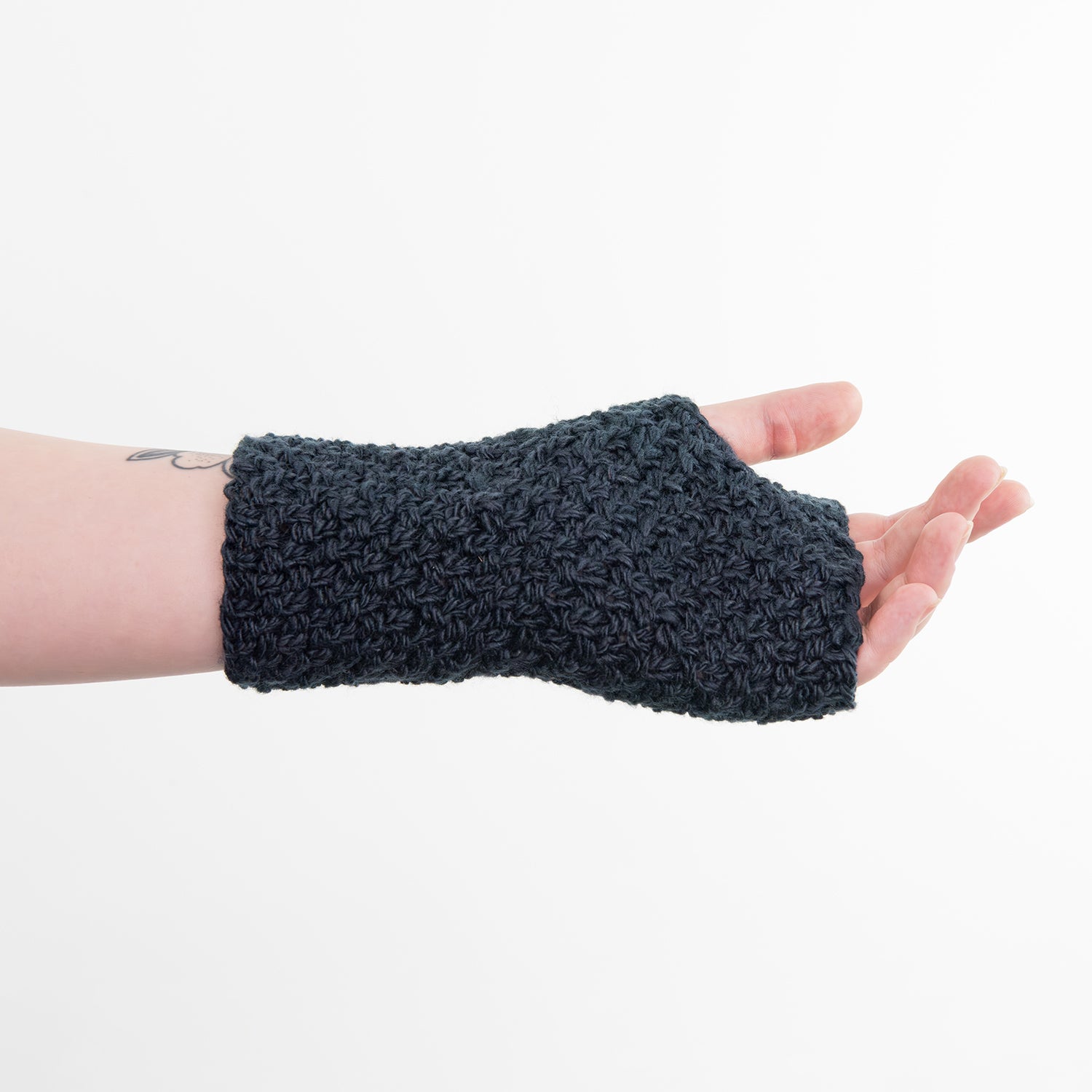 Shows a woman's hand wearing a dark blue wrist warmer