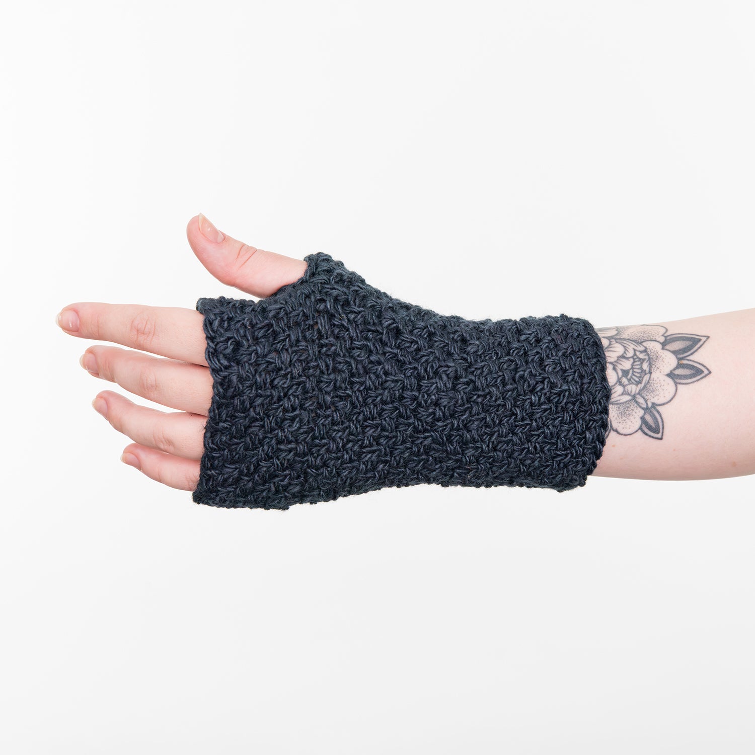 Shows a woman's hand wearing a dark blue wrist warmer