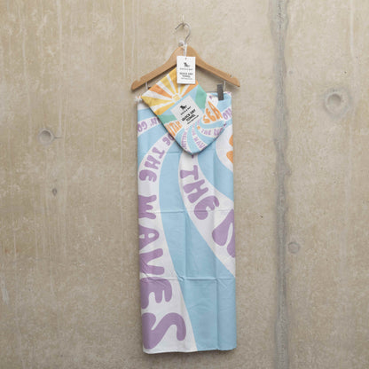 Beach towel, hung on a hanger with the carry pouch hooked onto the hanger