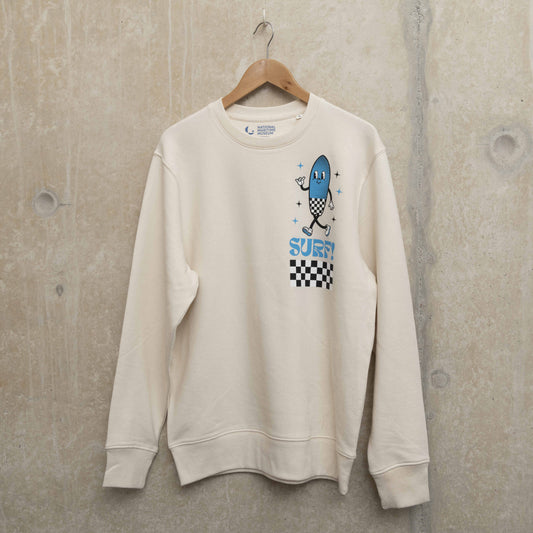 Front shot of cream coloured sweatshirt with surf character on left chest. Character is shaped like a surfboard in blue with black and white checkerboard design, with the word Surf underneath.