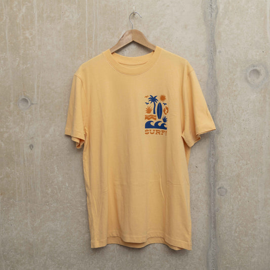 Front shot of light yellow t-shirt with surf motif on left chest. Motif shows waves, foot prints, surfboard, sun and palm tree.