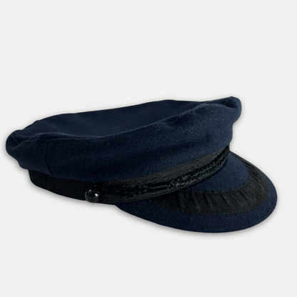 Navy blue cap with a decorative band on a light gray background