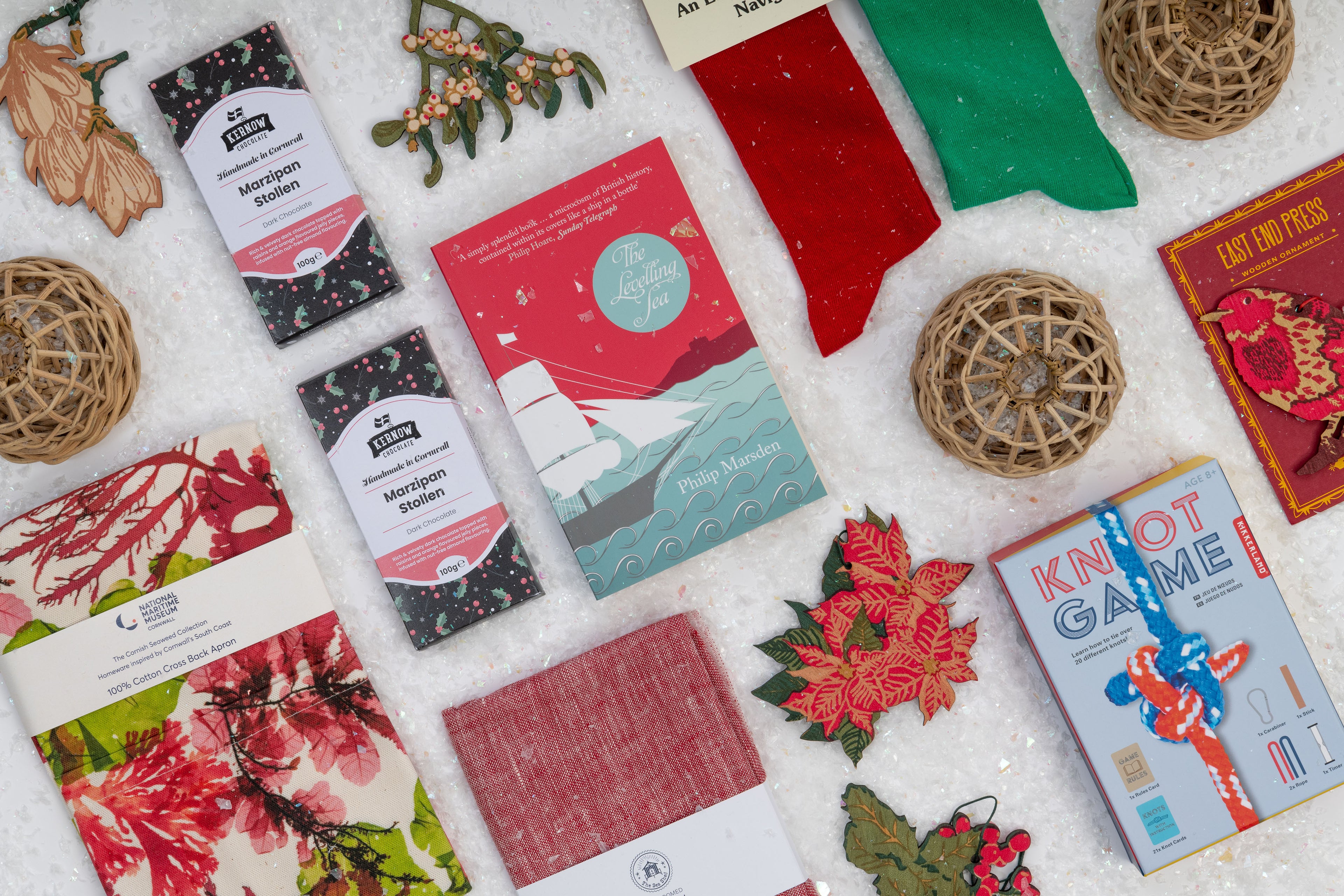 A photograph of colourful Christmas products arranged on a snowy background.