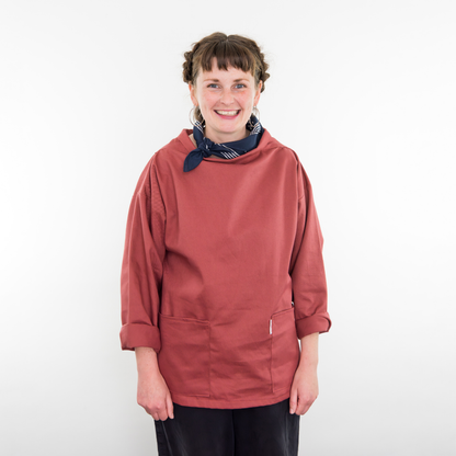 Person wearing a red smock with a white background