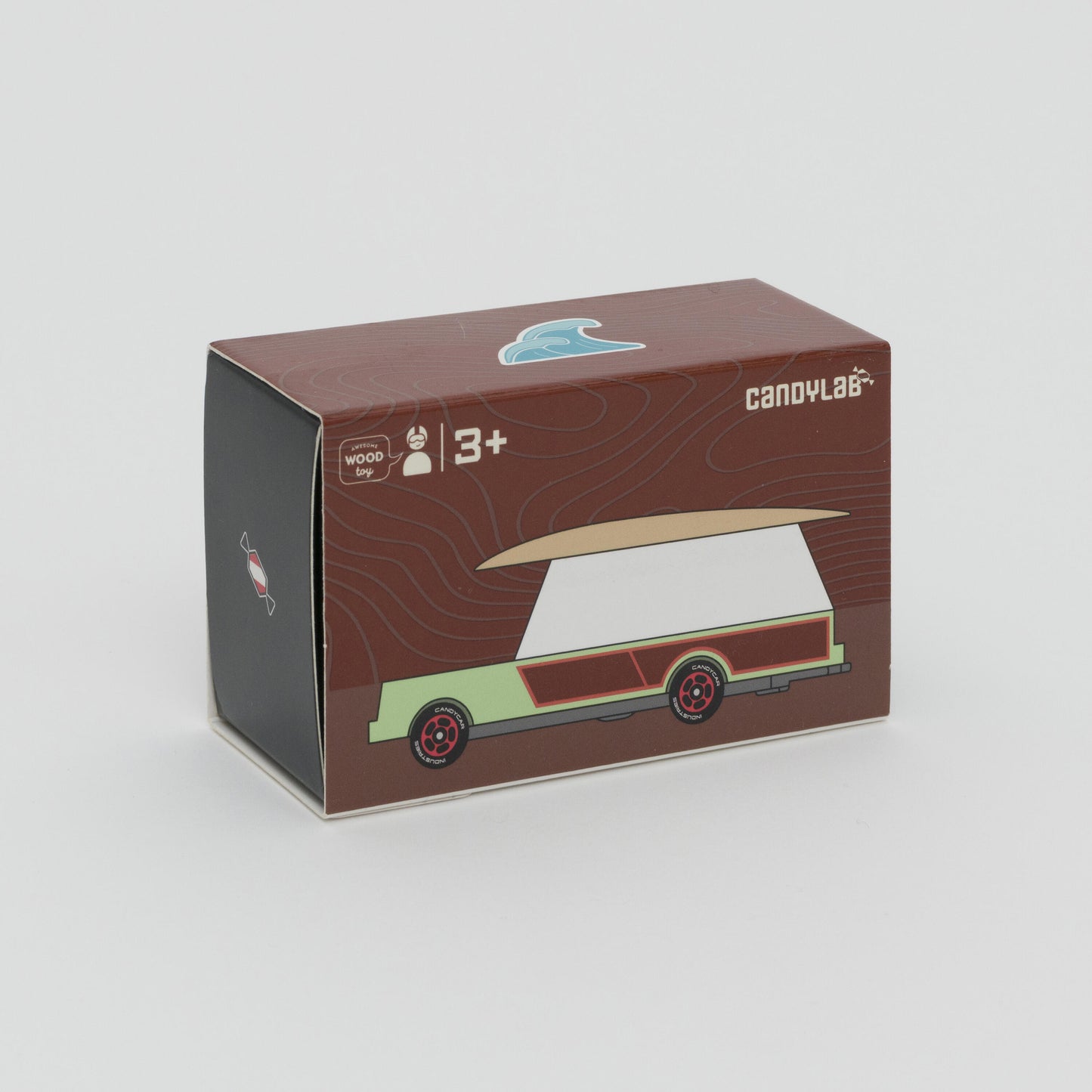 Shot of packaging box of mint green and white car with wooden surfboard on the roof. 