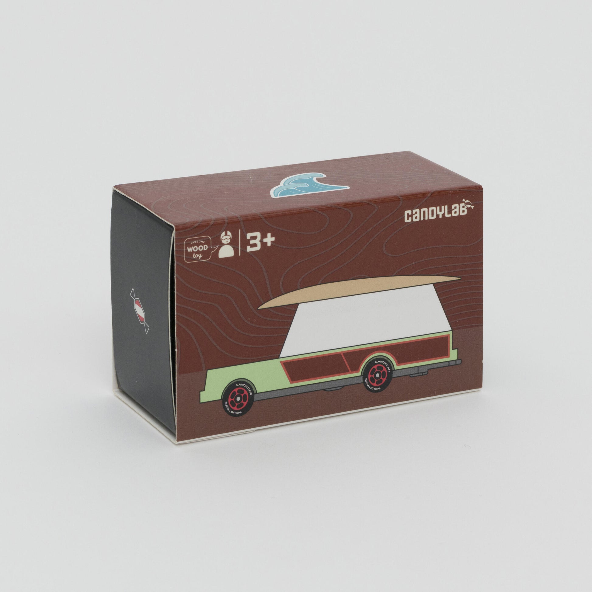 Shot of packaging box of mint green and white car with wooden surfboard on the roof. 