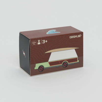Shot of packaging box of mint green and white car with wooden surfboard on the roof. 