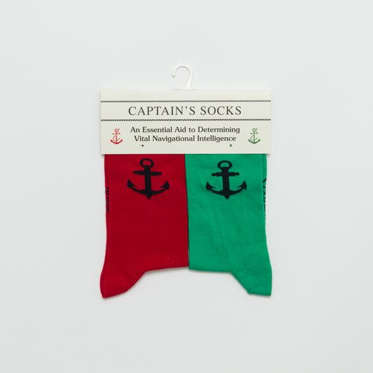 one red and one green sock with anchor design