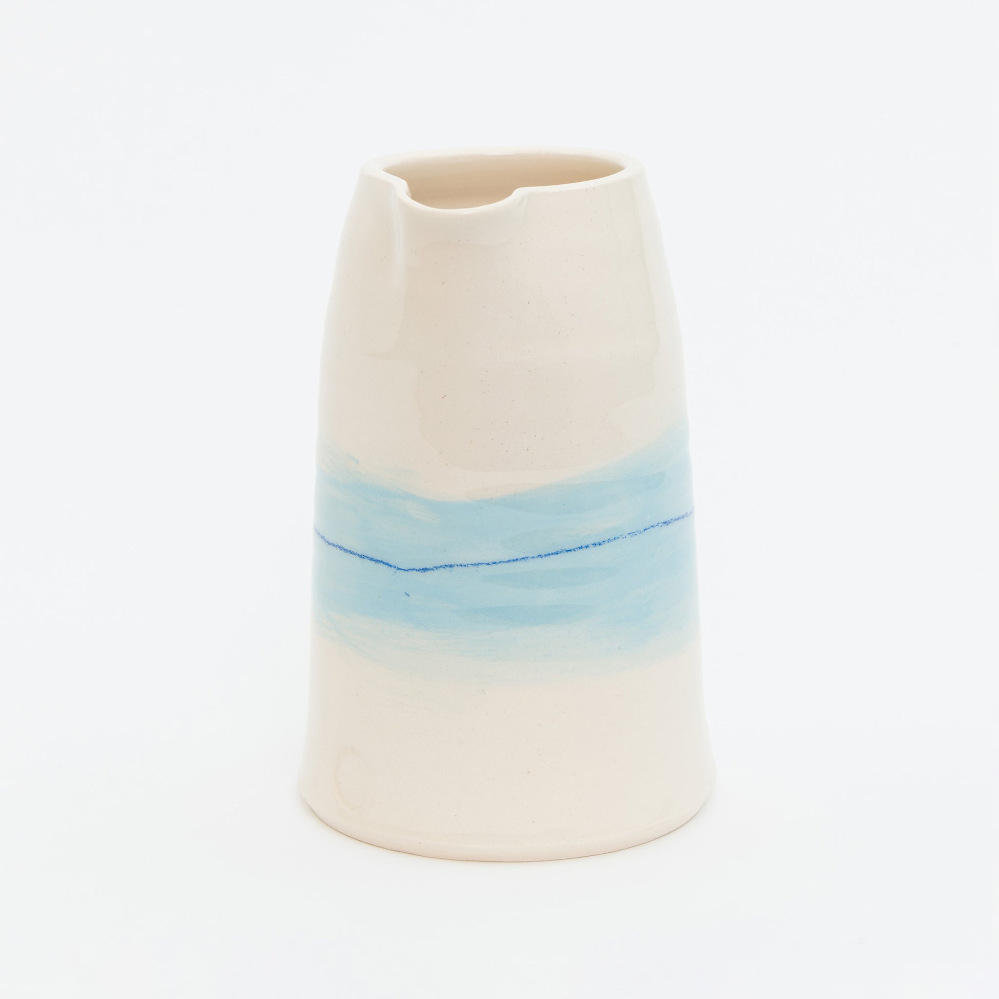 Ceramic vase with a gradient from beige to blue on a white background