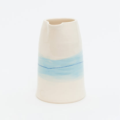 Ceramic vase with a gradient from beige to blue on a white background