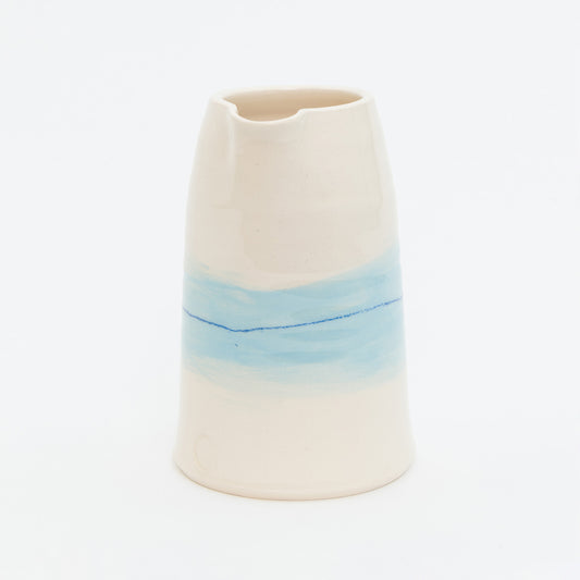 Ceramic vase with a gradient from beige to blue on a white background