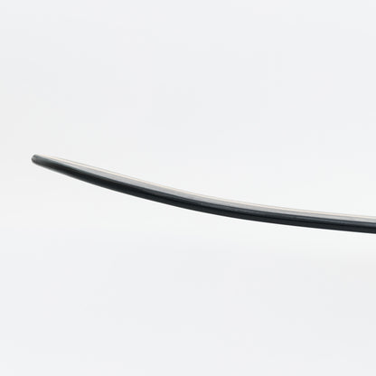 sild shot of curved black wooden bellyboard on a white background