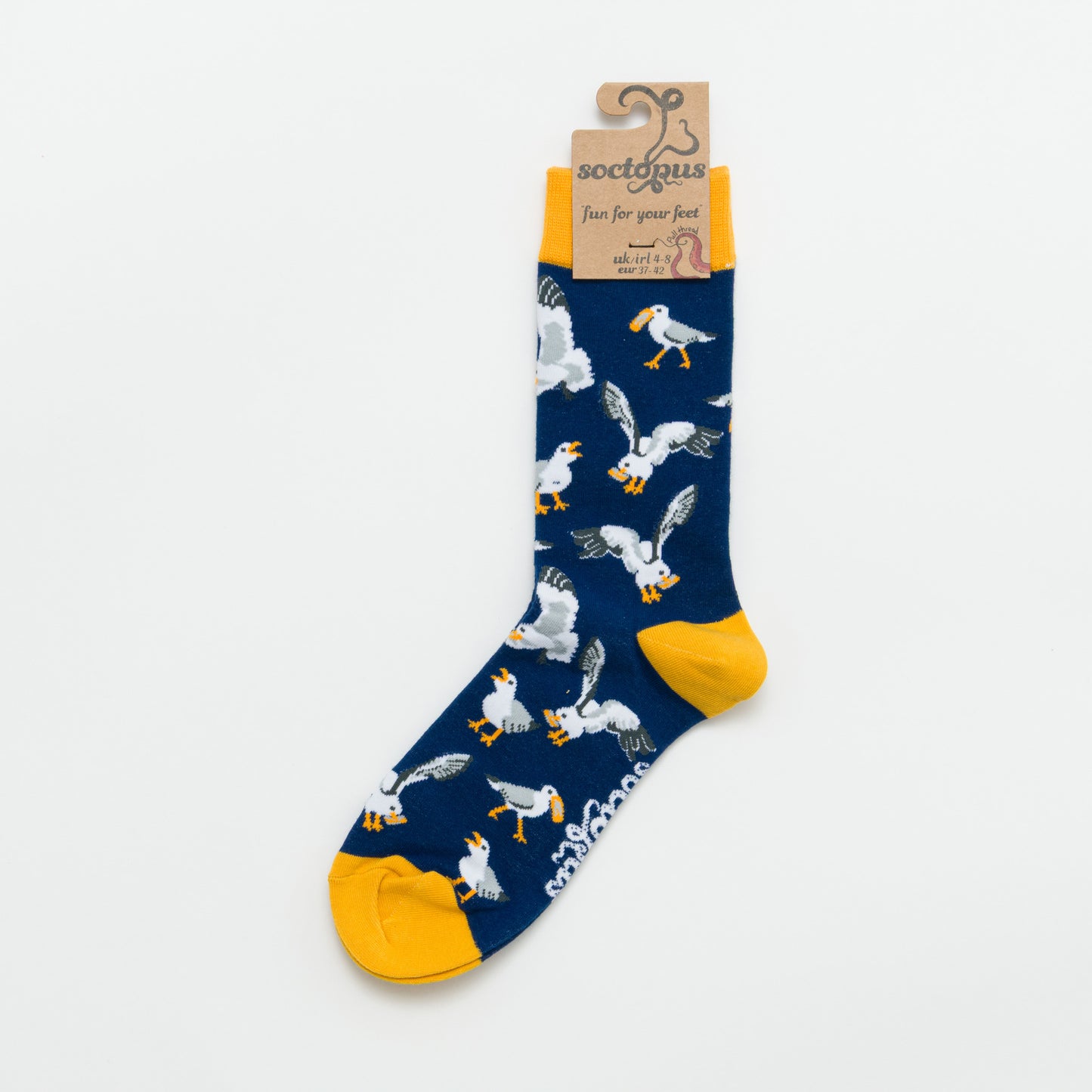 Navy sock with seagull pattern and yellow accents photographed on a white background
