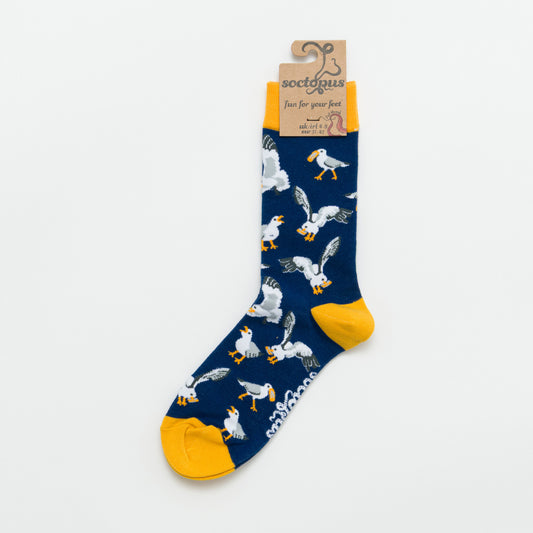 Navy sock with seagull pattern and yellow accents photographed on a white background