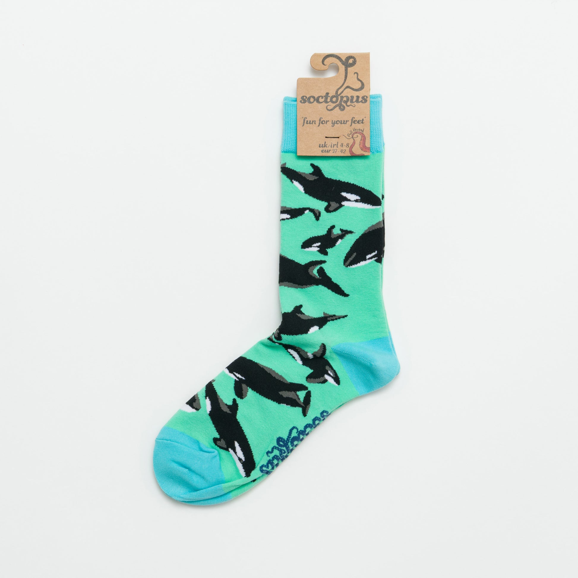 Sock with orca whale pattern on a light blue background.