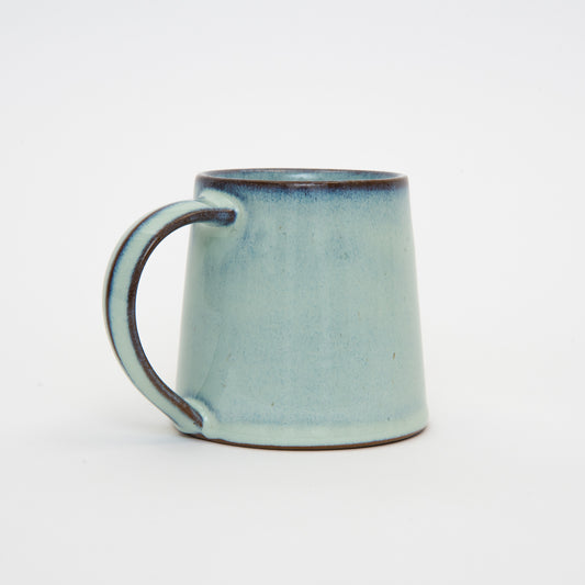 Light blue green hand made mug wider at the base than at the top