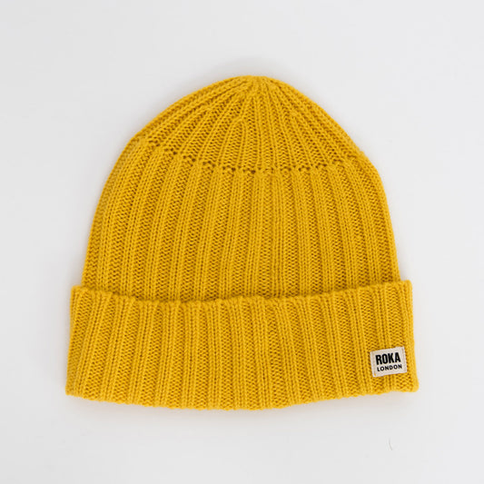 Yellow coloured knitted beanie with ROKA branding