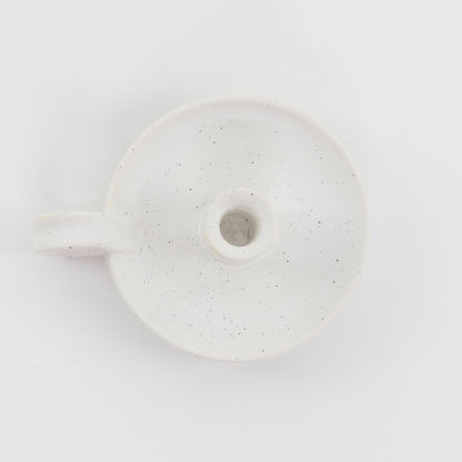 White with cream speckles, ceramic candle holder, shot from above.